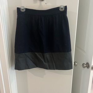 Super fashionable navy and black skirt. Faux leather detail on bottom.